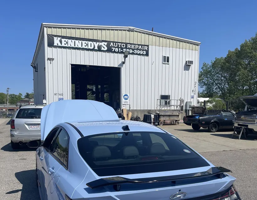Kennedy's Auto Repair shop front with the sign above the service door