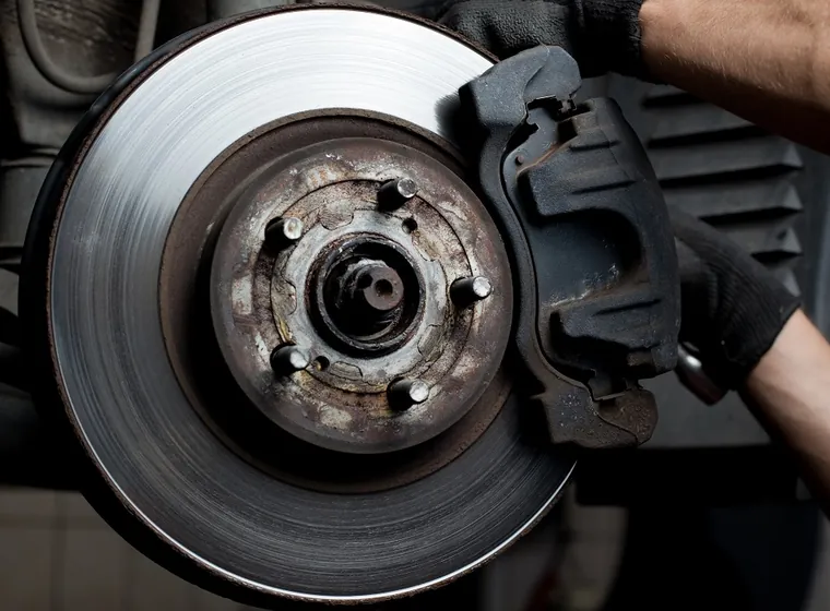 New brake disc and caliper being fitted