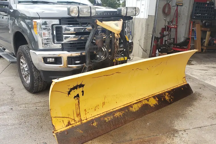 Pickup truck with a plow in the Kennedy’s service bay