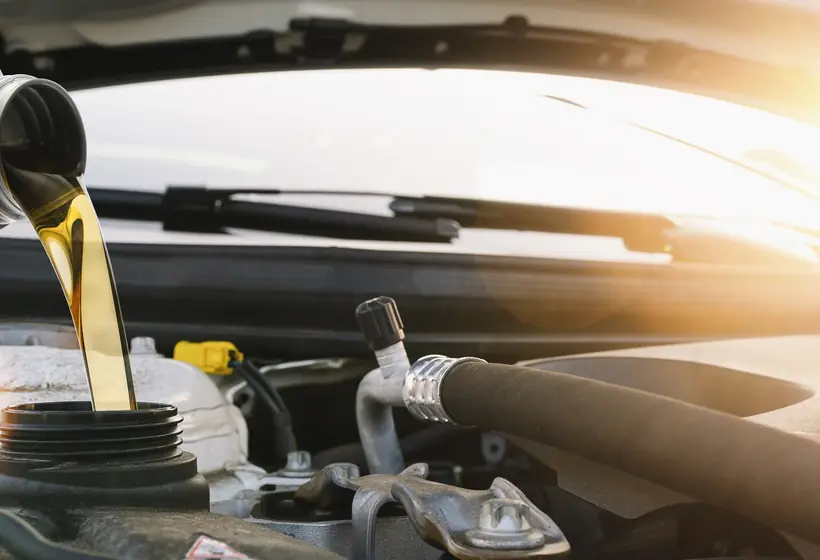 Fresh oil being poured into an engine through a funnel